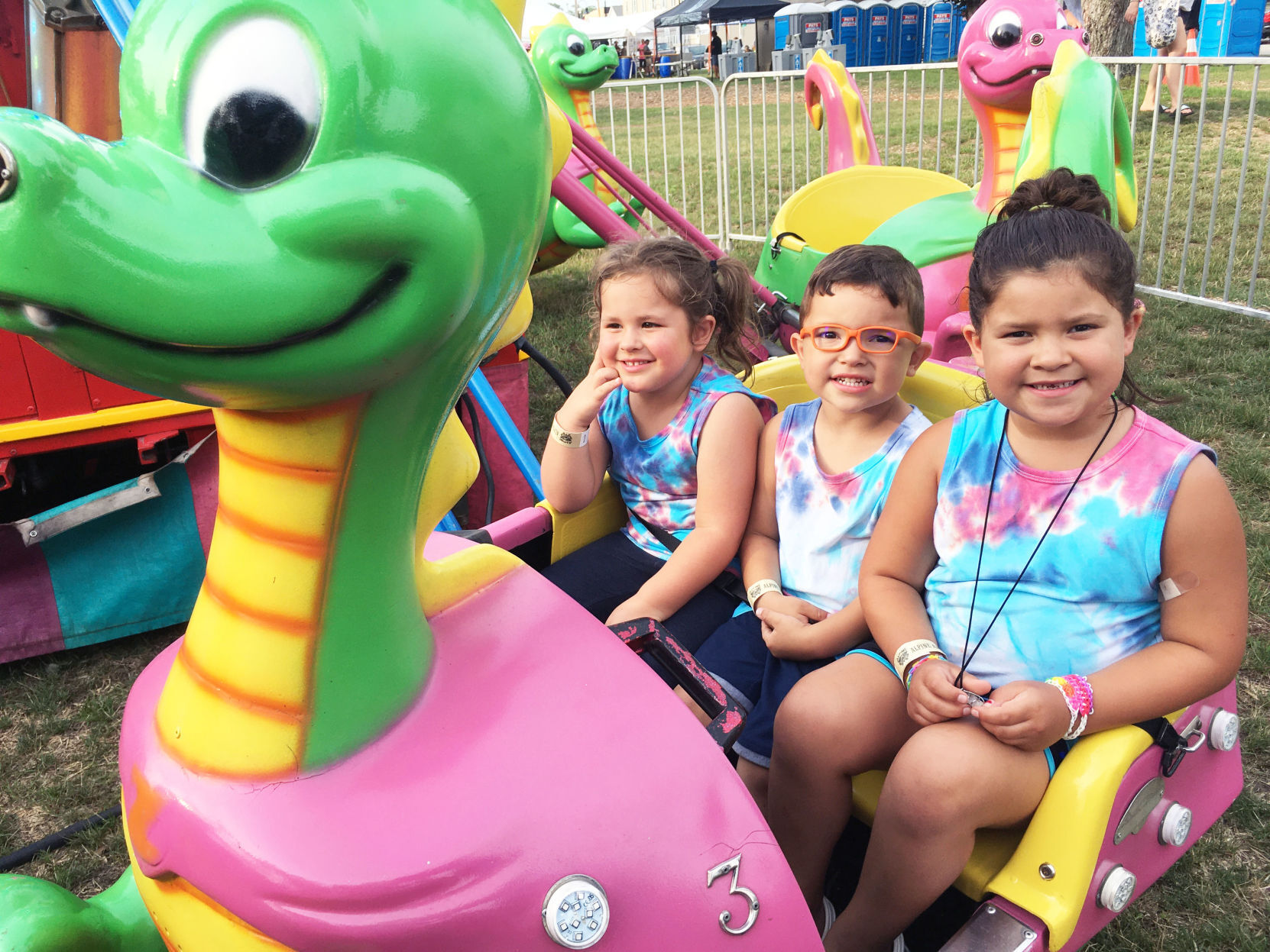 Sydney Bartlett with cousins on carnival ride at Lions Fun Fest in Waterford